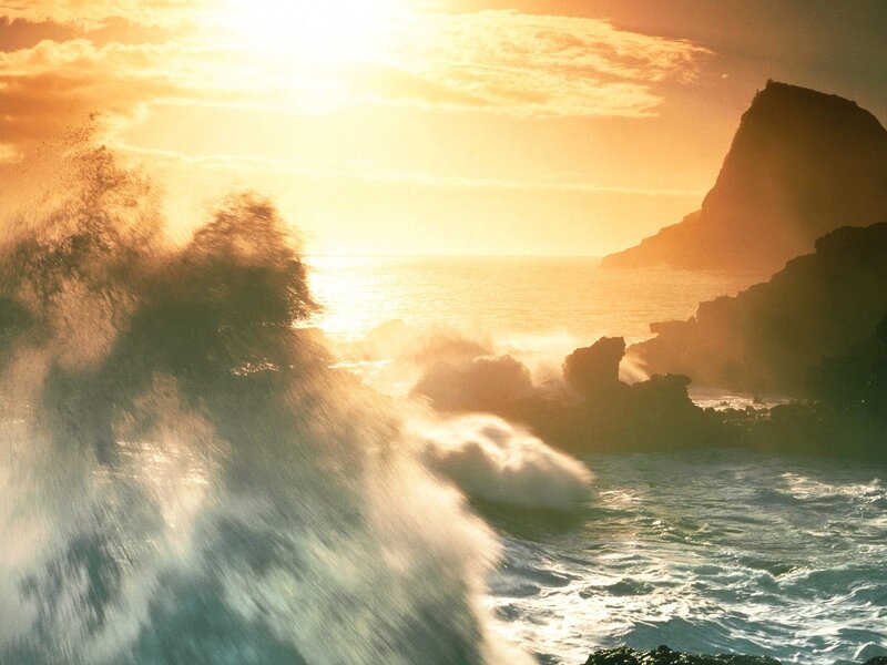 Ocean waves crashing at sunset