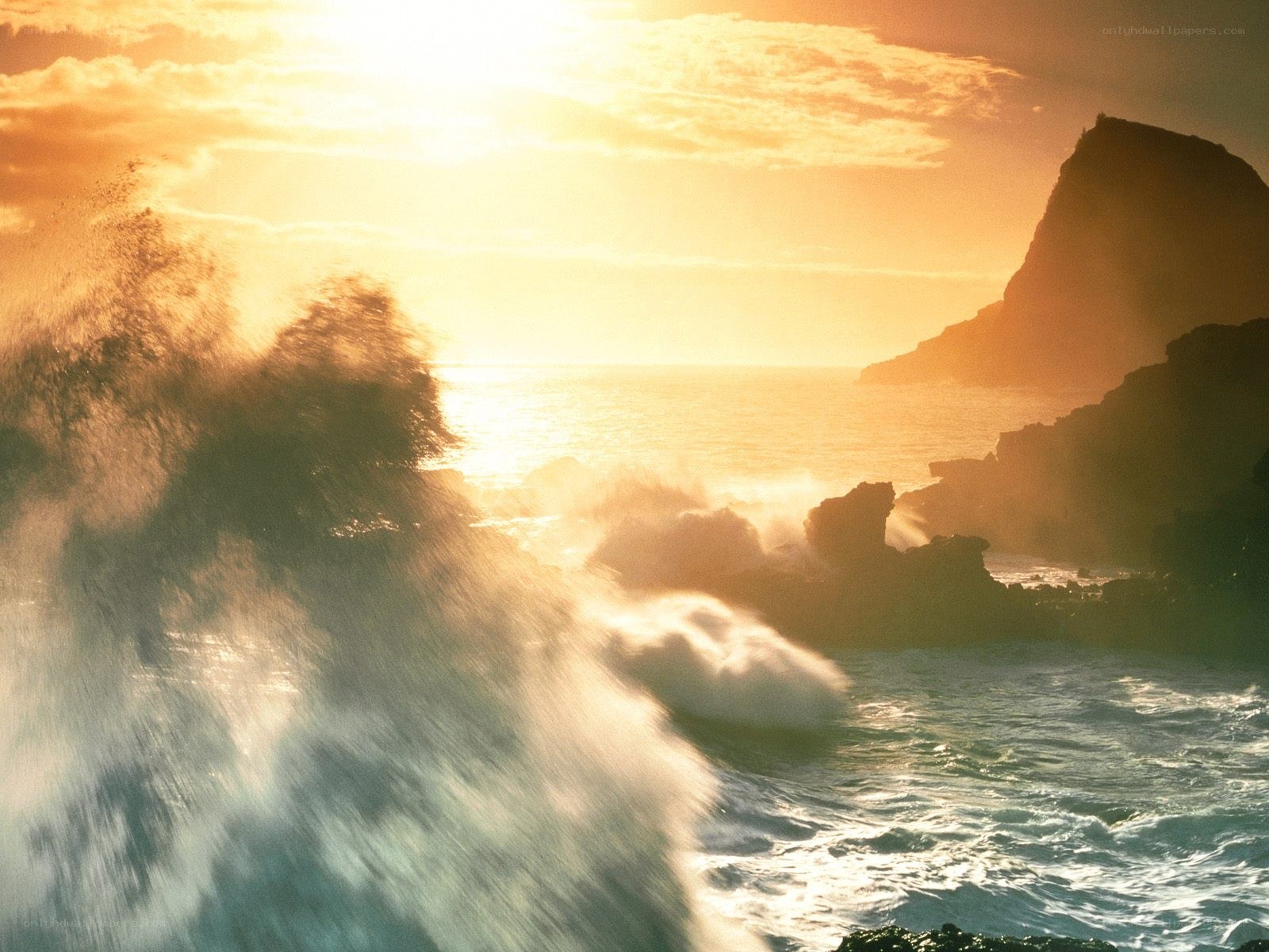 Ocean waves crashing at sunset