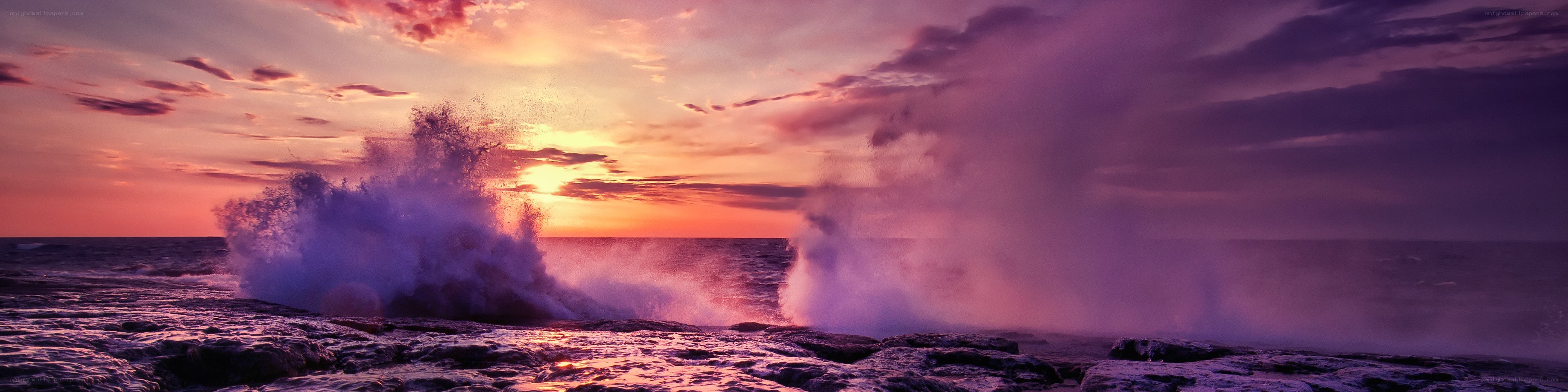Ocean waves crashing at sunset