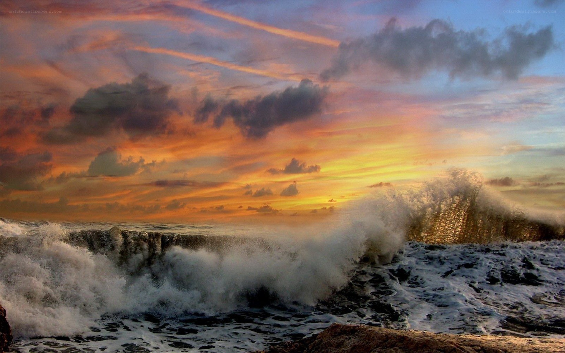 Ocean waves crashing at sunset