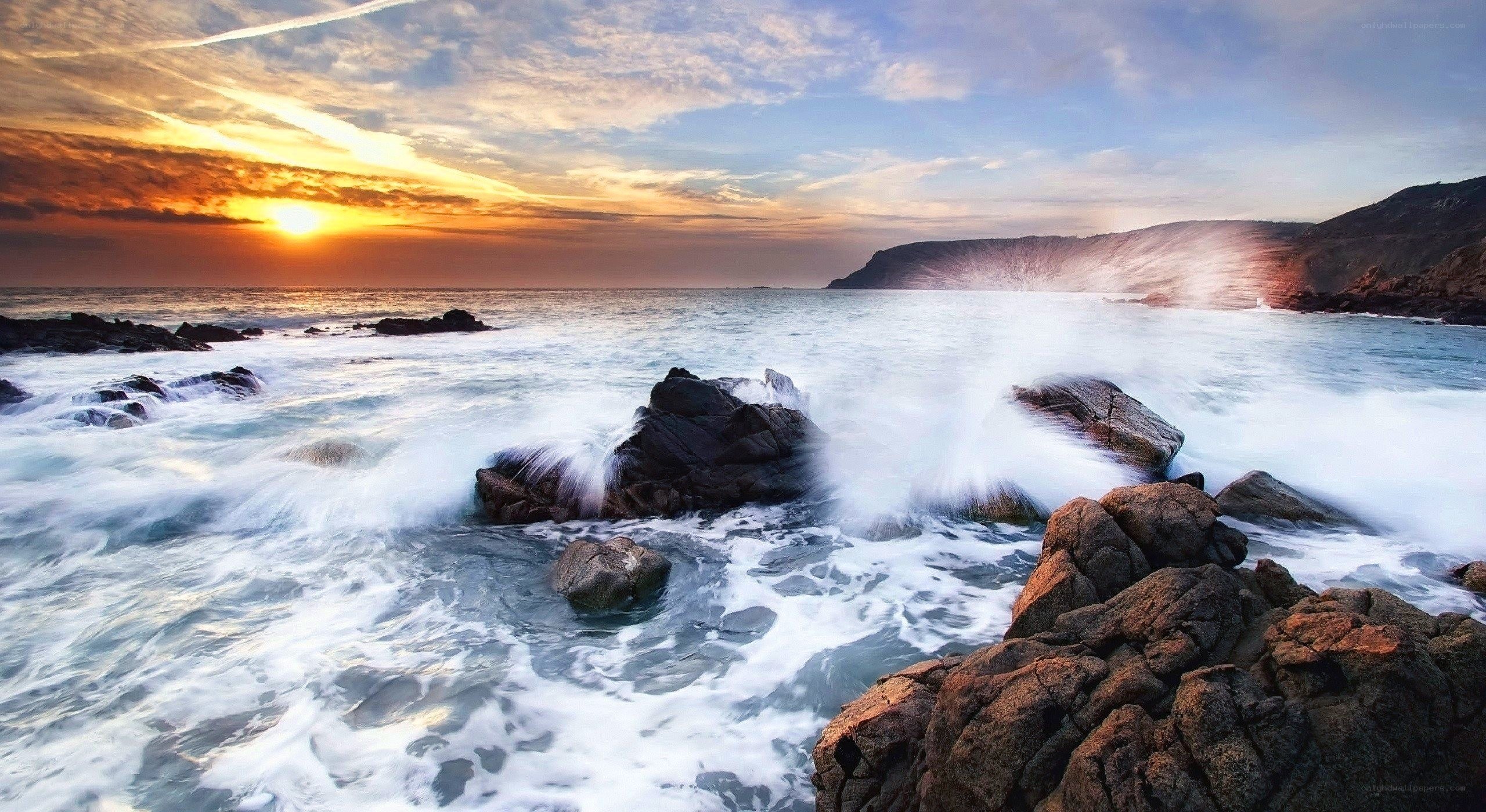 Ocean waves crashing at sunset