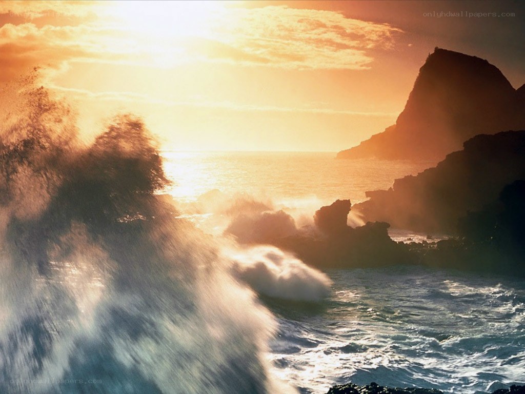Ocean waves crashing at sunset