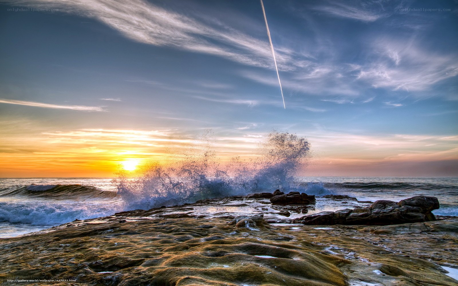 Ocean waves crashing at sunset