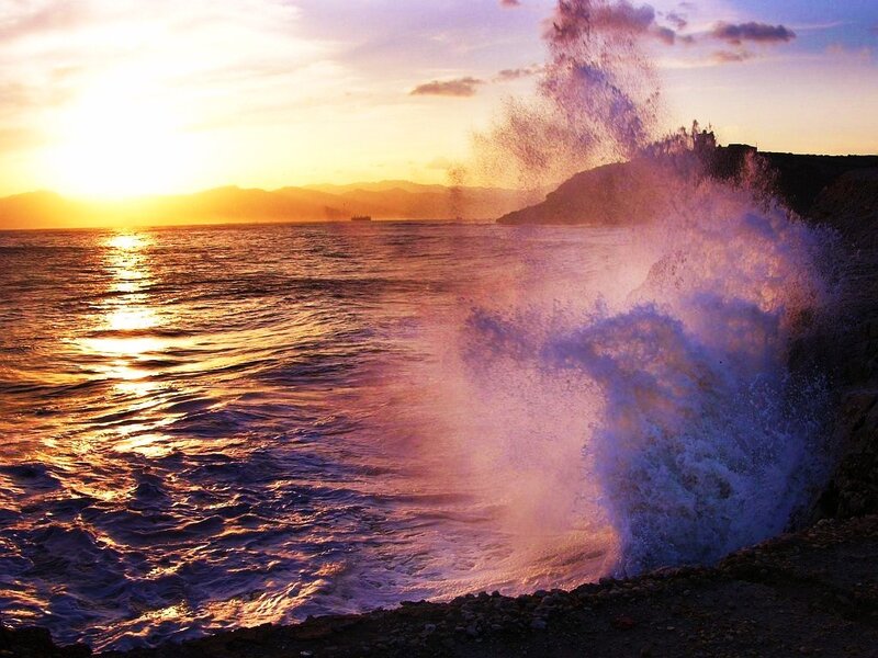 Ocean waves crashing at sunset