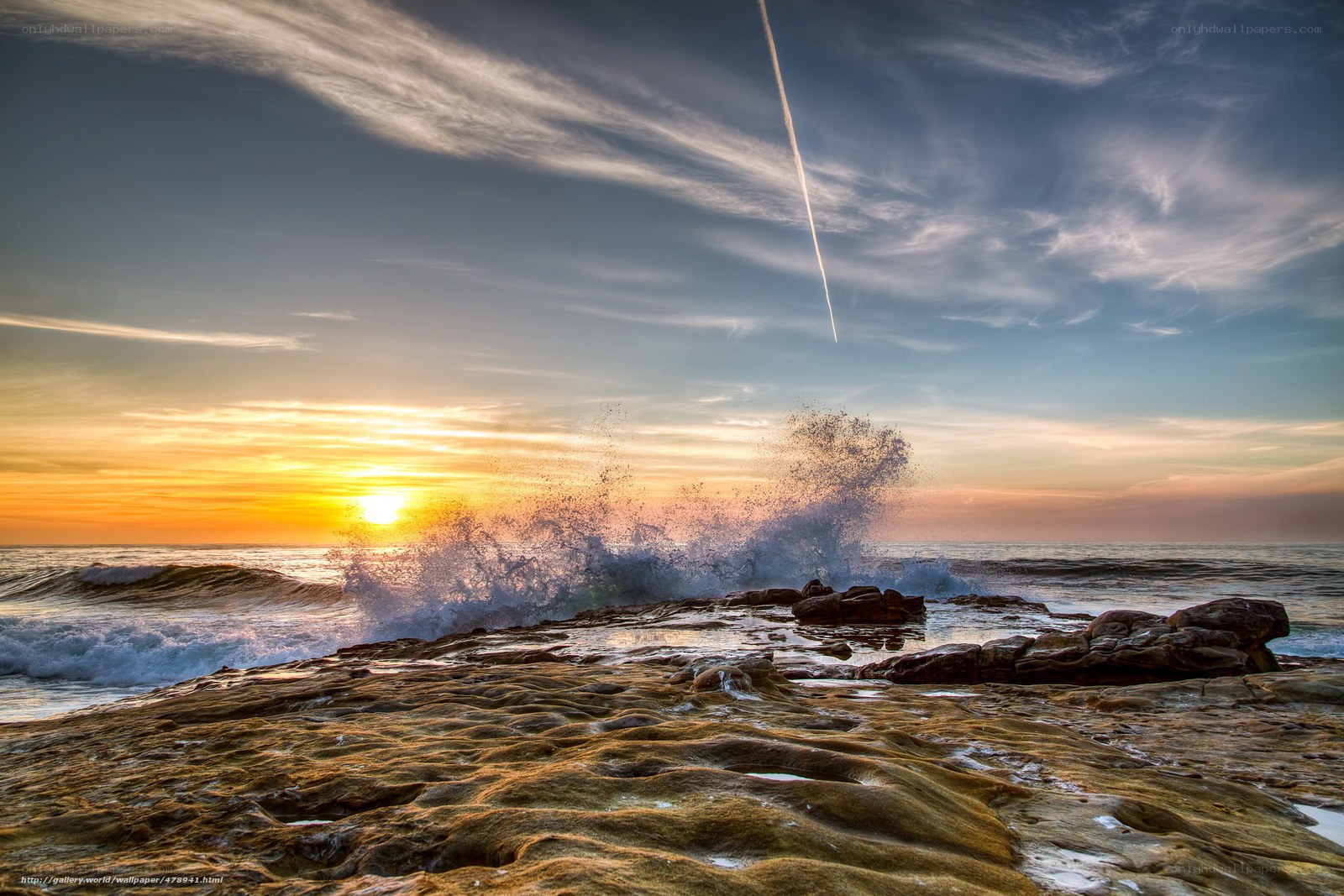 Ocean waves crashing at sunset