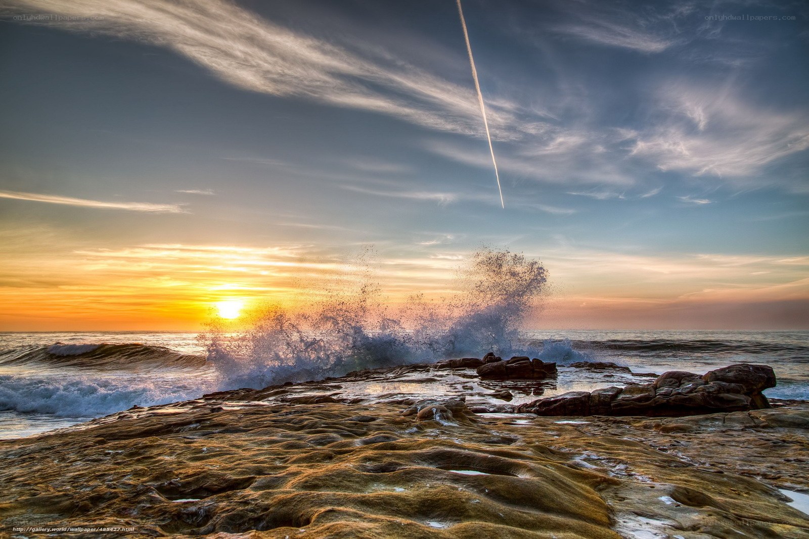 Ocean waves crashing at sunset