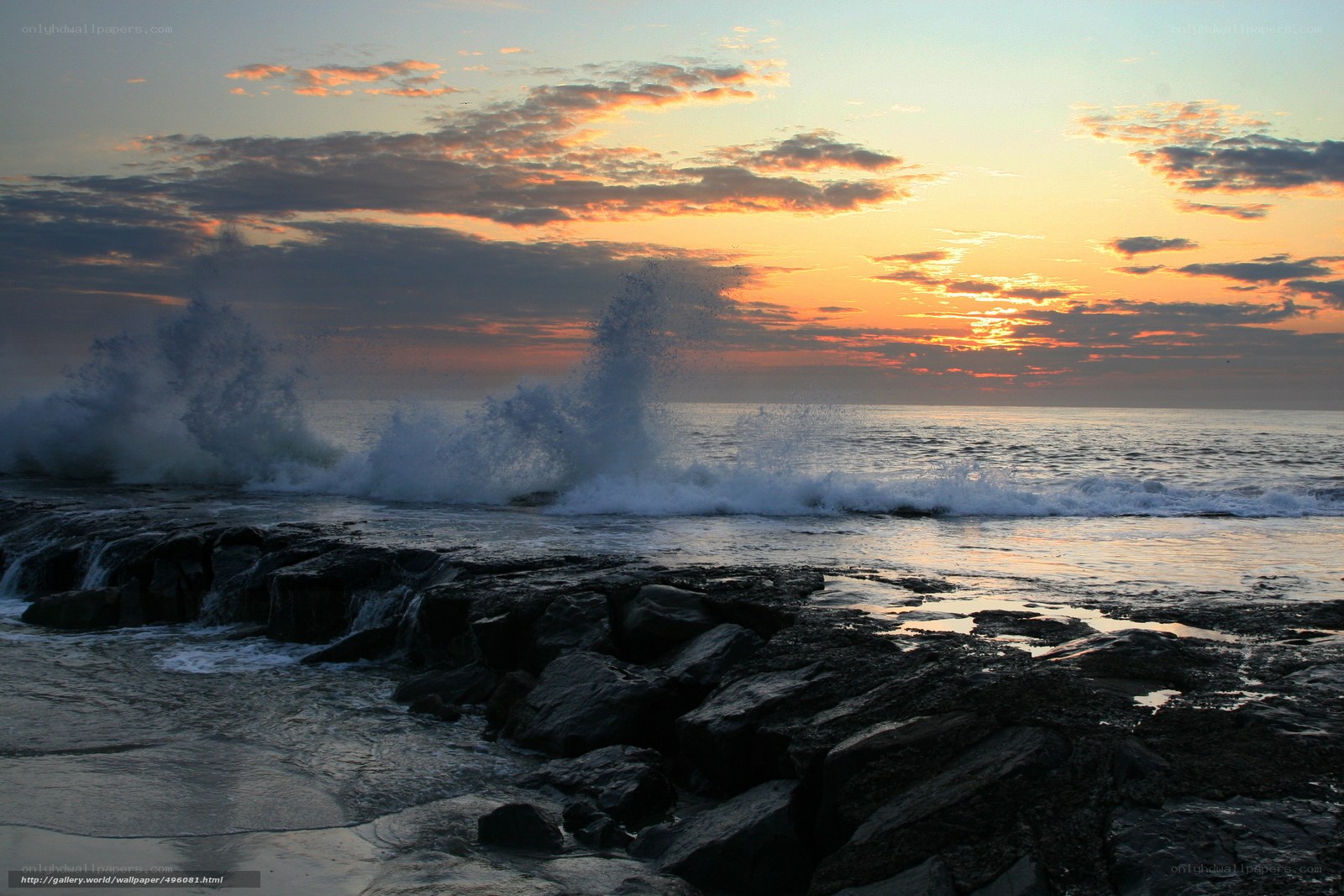 Ocean waves crashing at sunset
