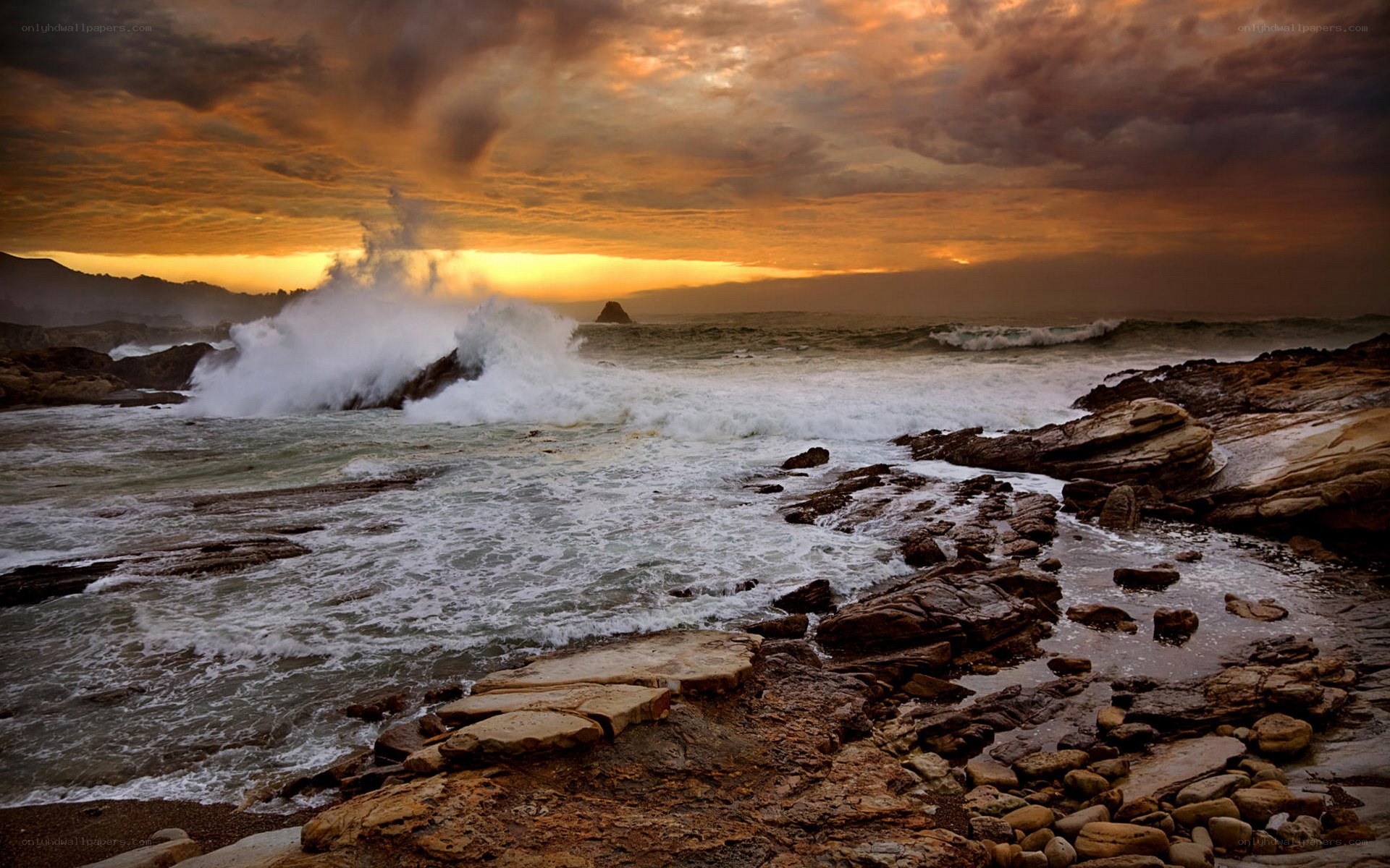 Ocean waves crashing at sunset