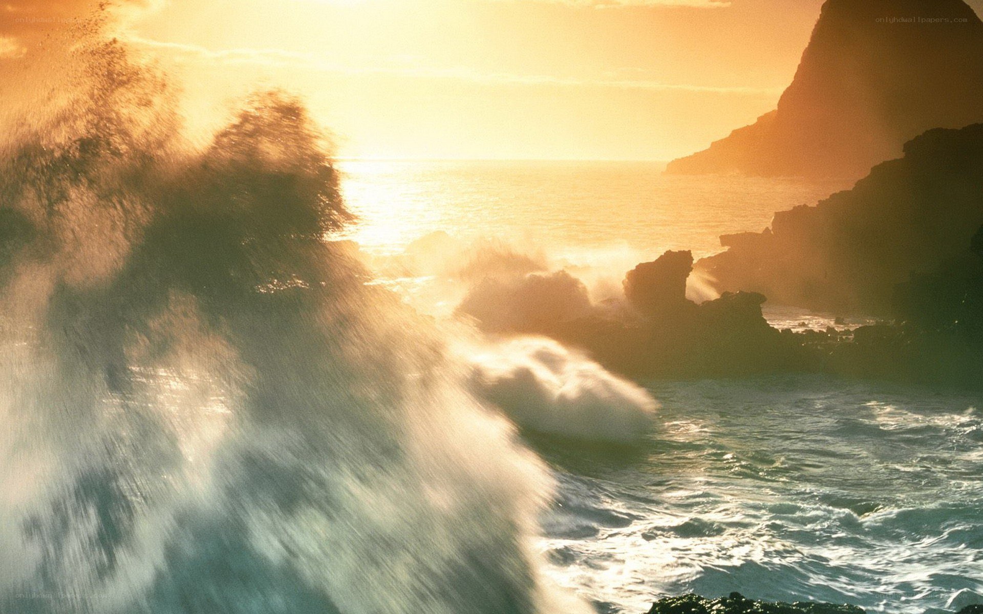 Ocean waves crashing at sunset