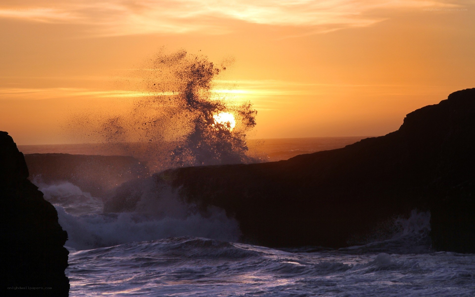 Ocean waves crashing at sunset