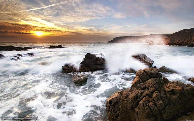 Ocean waves crashing at sunset