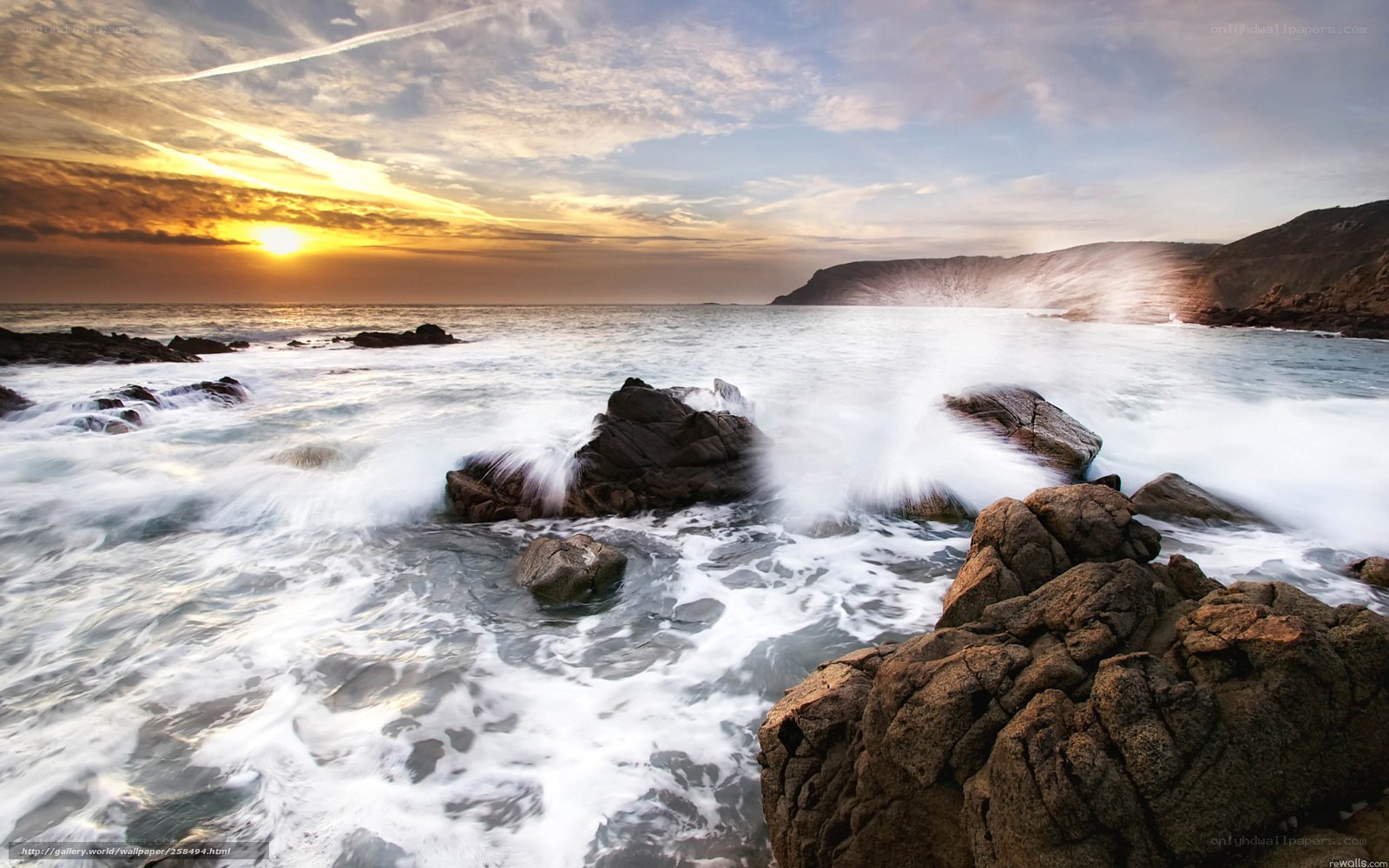 Ocean waves crashing at sunset