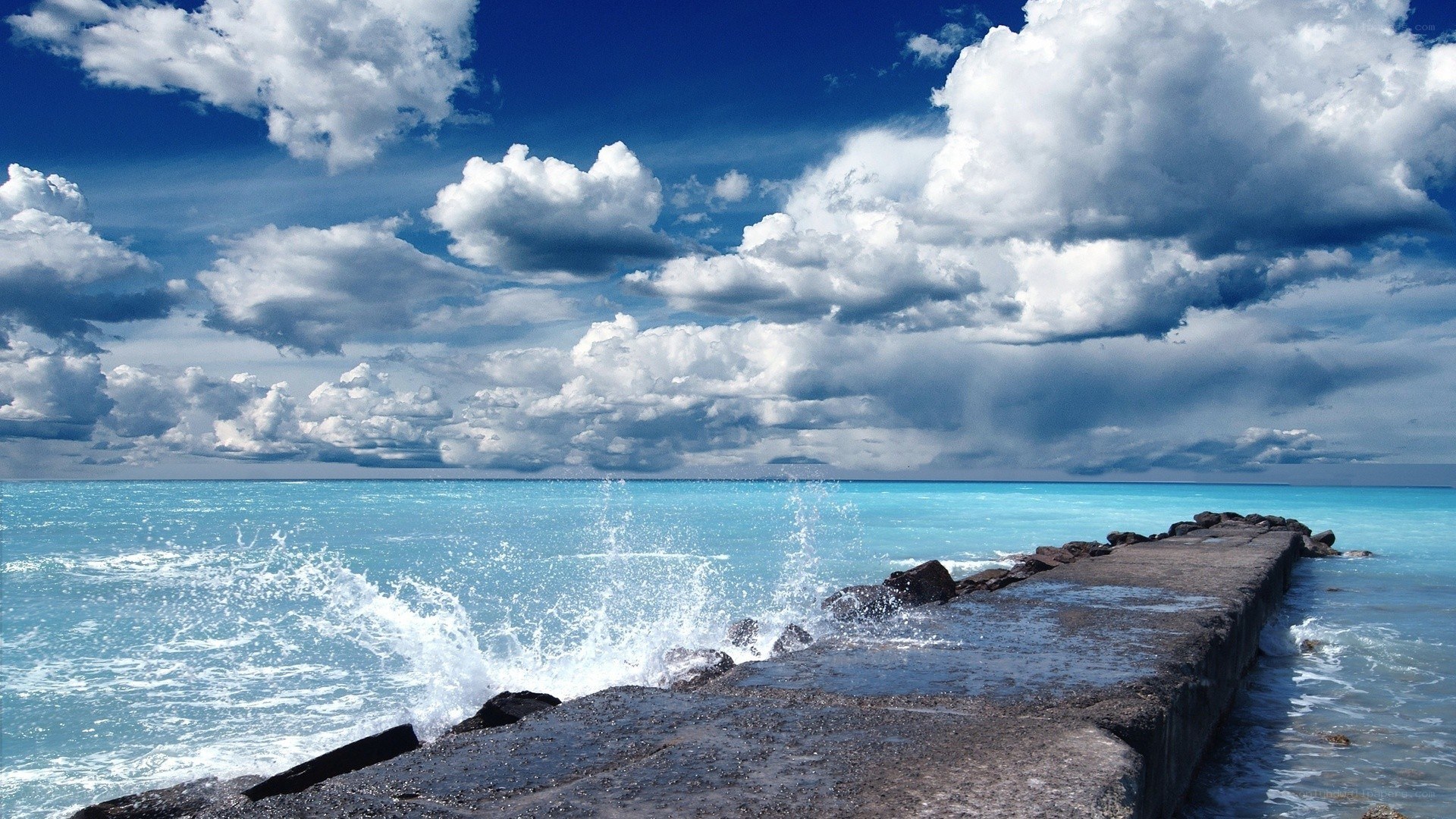 Ocean waves crashing on a pier
