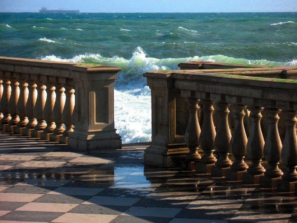 Ocean waves crashing on a stone balcony