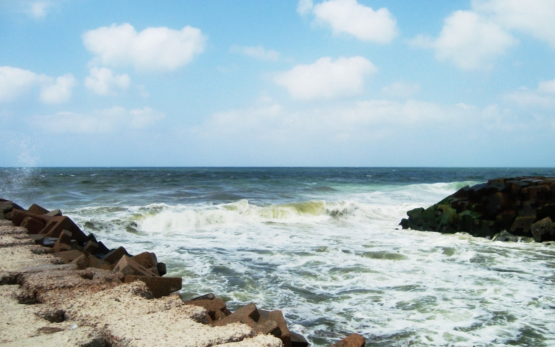 Ocean waves crashing on breakwaters