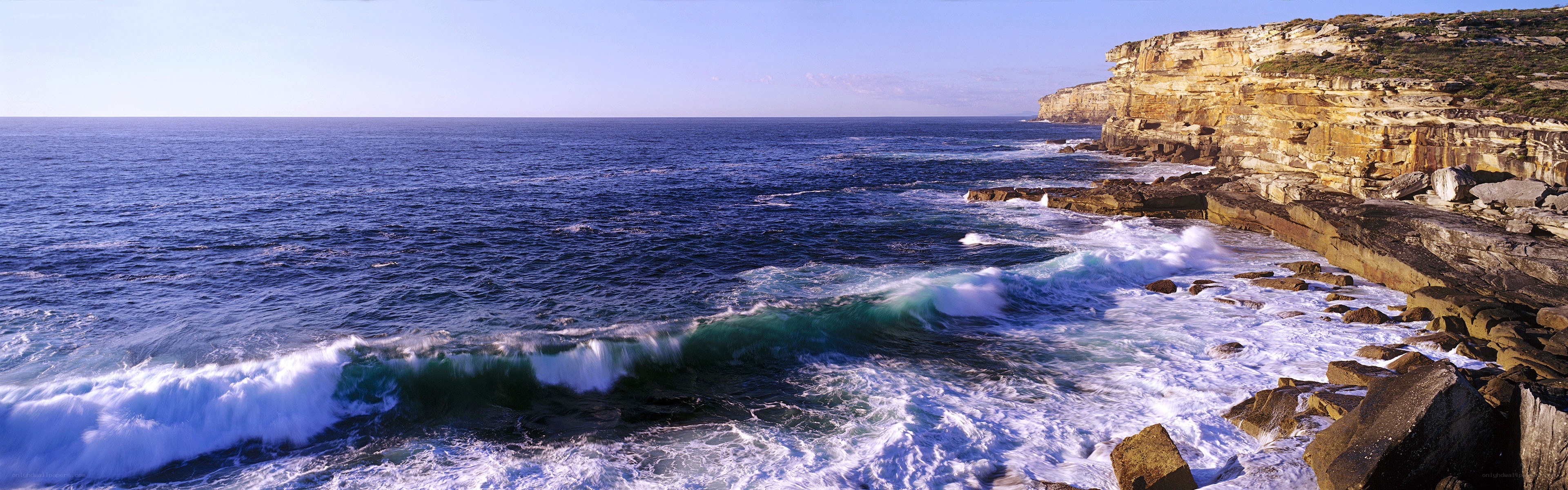 Ocean waves crashing on cliffs