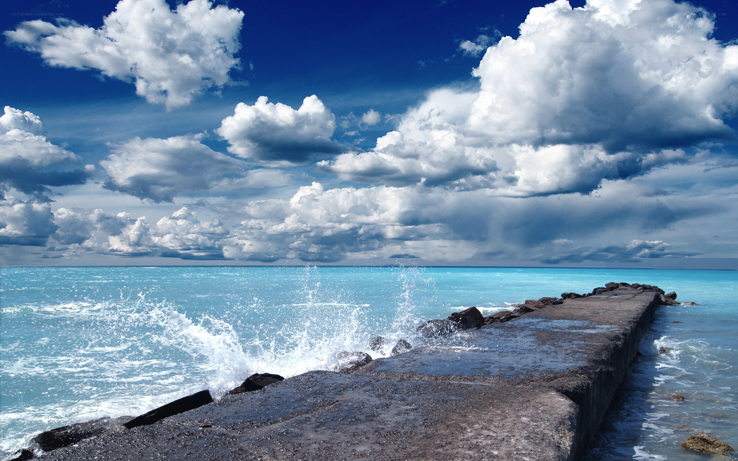 Ocean waves crashing on pier