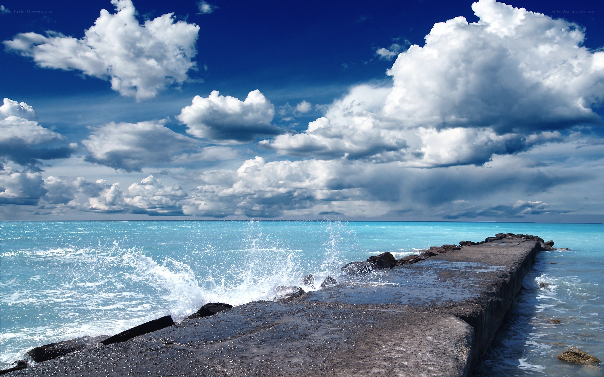 Ocean waves crashing on pier