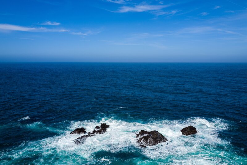 Ocean Waves Crashing on Rocks — Blue, Serene, Afternoon