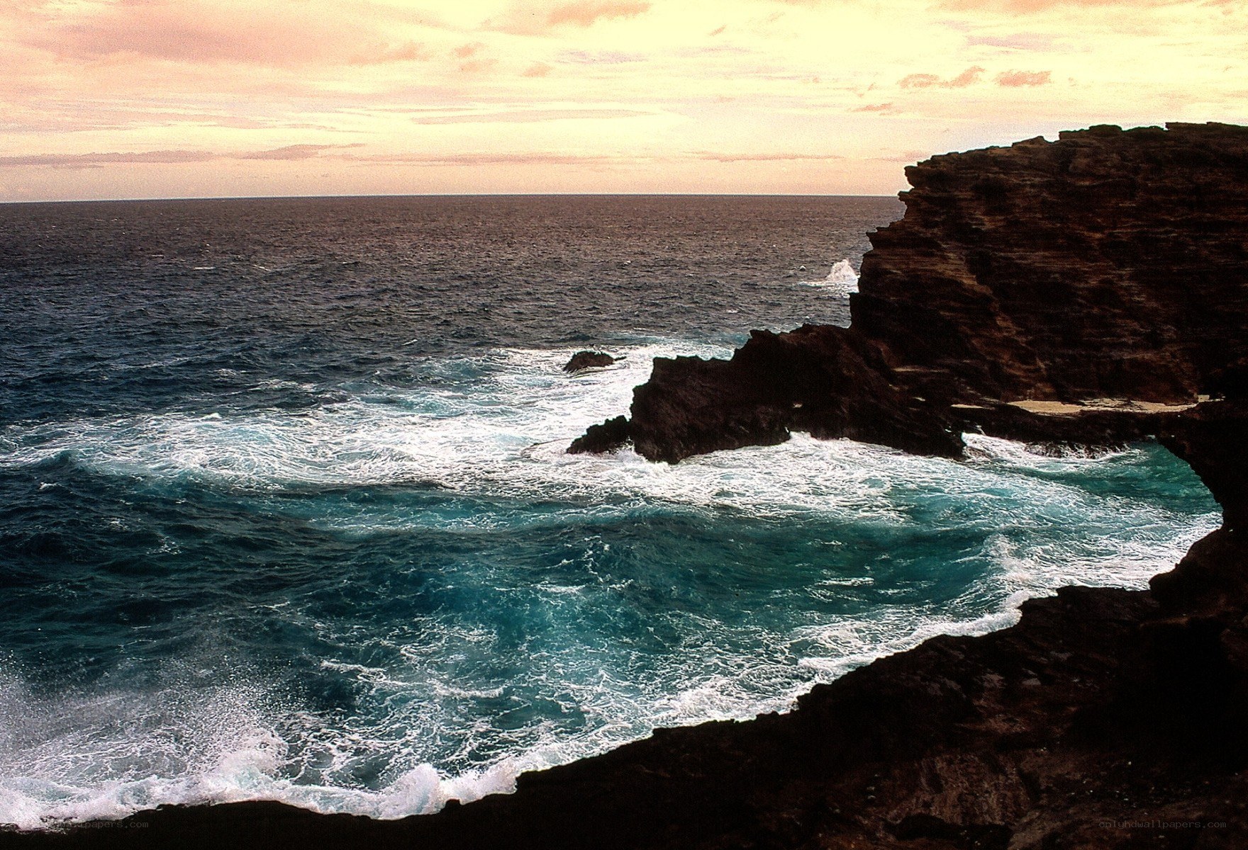 Ocean waves crashing on rocky cliffs