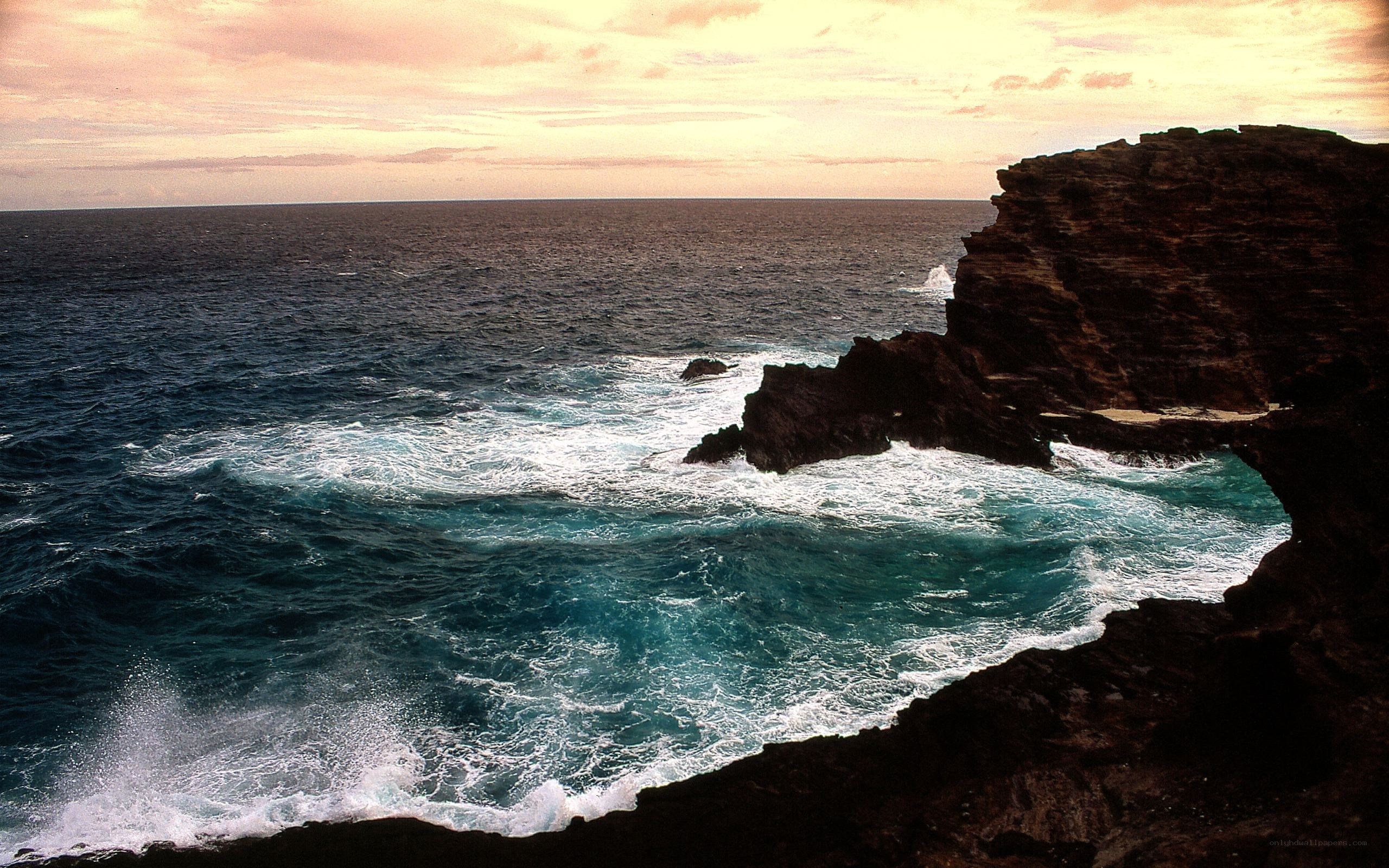 Ocean waves crashing on rocky cliffs