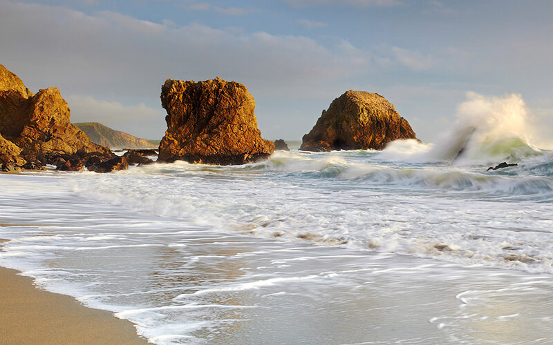 Ocean waves crashing on rocky shore