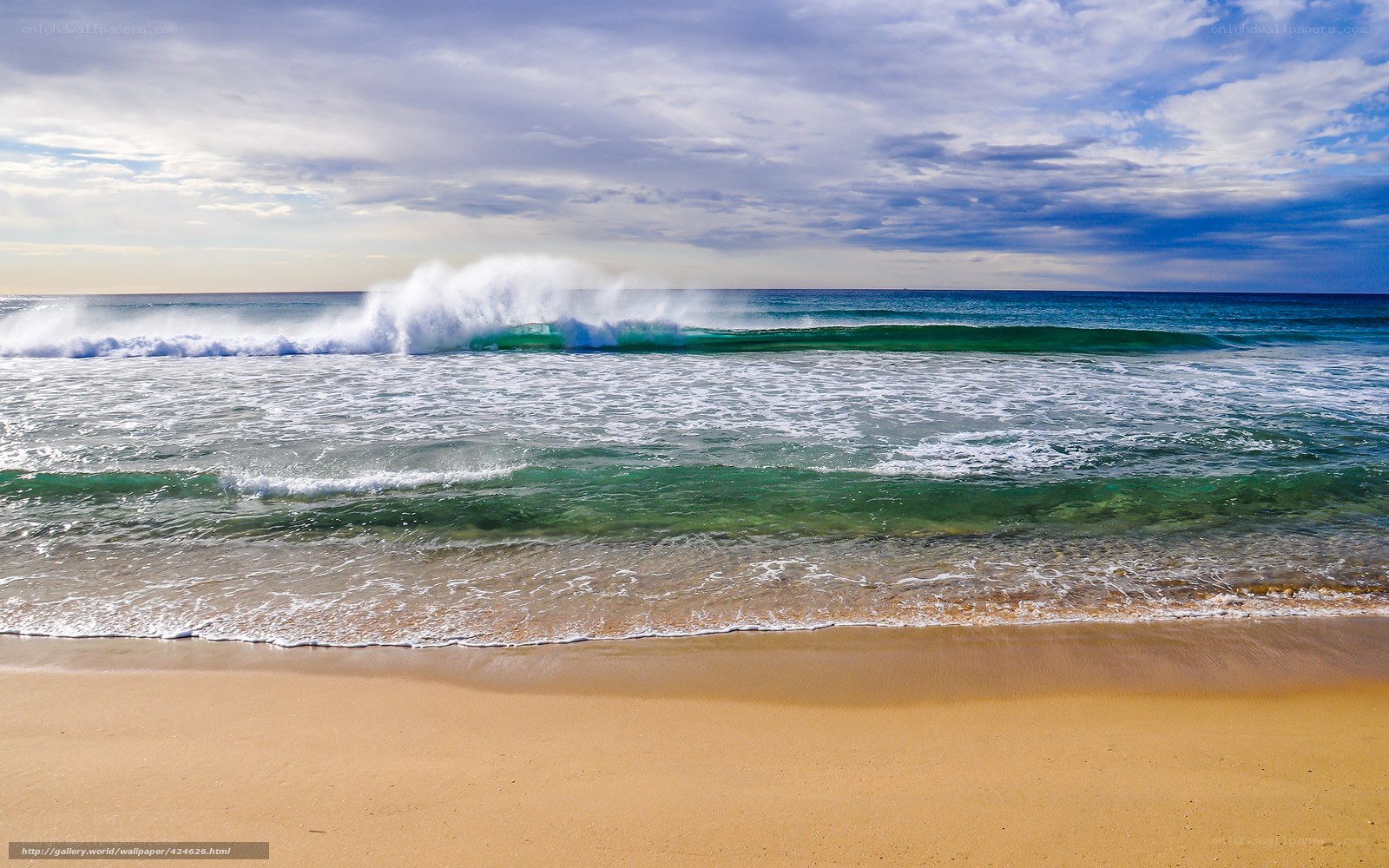 Ocean waves crashing on sandy beach