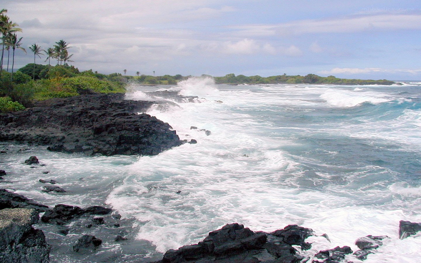 Ocean waves crashing on volcanic rocks