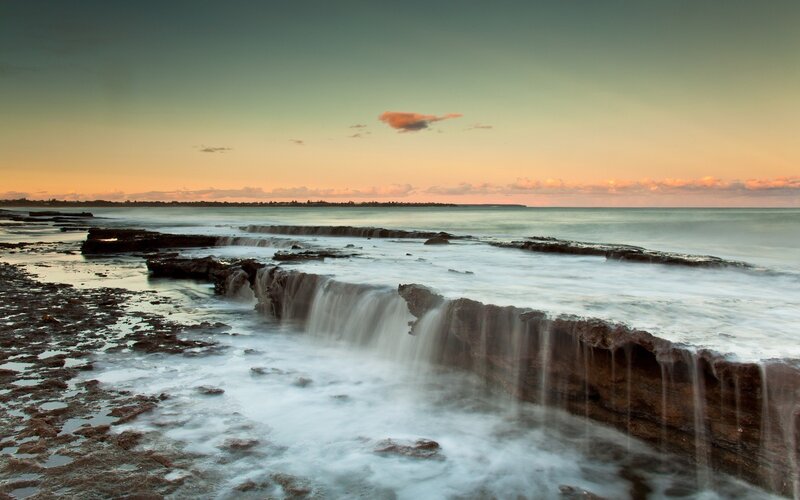 Ocean Waves on Rocks — Blue, Serene, Sunset, Photograph, Sea, Sky, Orange, Brown