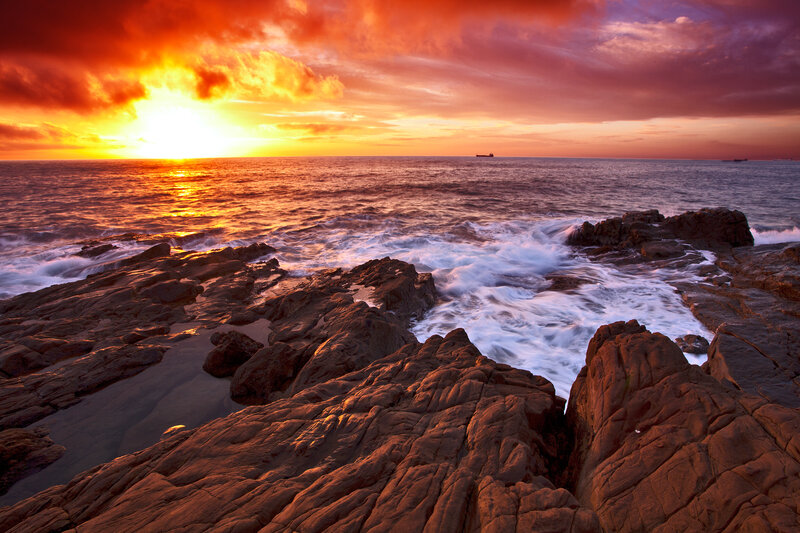 Ocean Waves on Rocks — Orange, Dramatic, Sunset, Photograph, Sun, Clouds, Ship