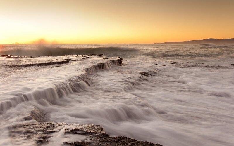 Ocean Waves on Rocks — Orange, Serene, Sunset, Photograph, Sky, White