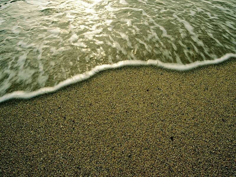 Ocean waves on sandy beach