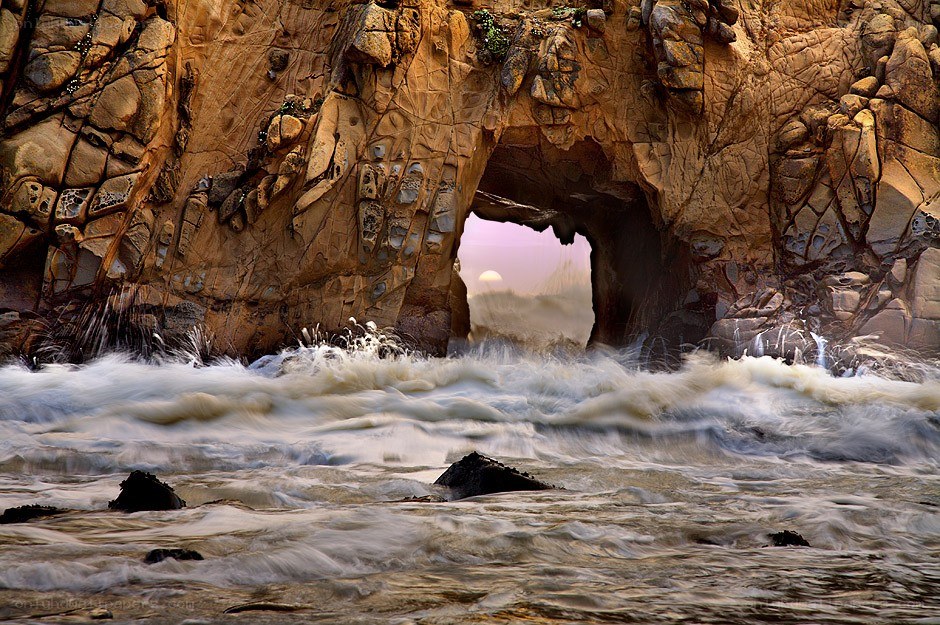 Ocean waves through rock arch