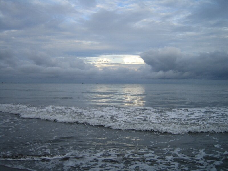 Ocean waves under cloudy sky