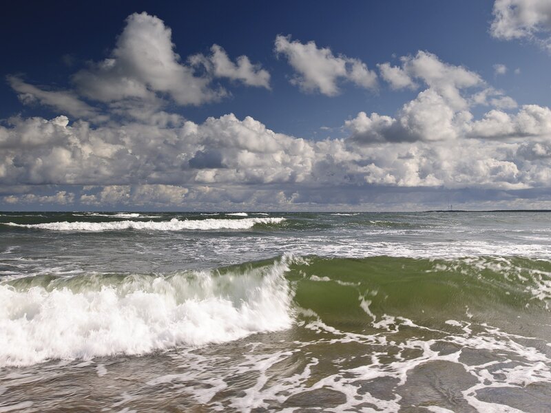 Ocean waves under cloudy sky