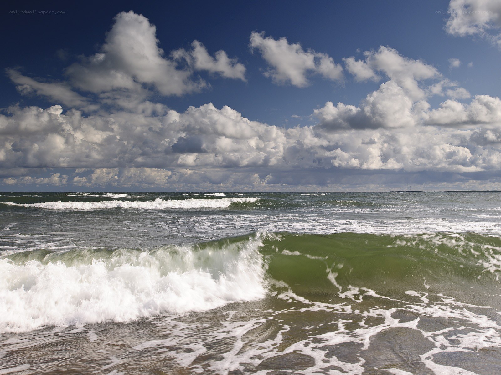 Ocean waves under cloudy sky