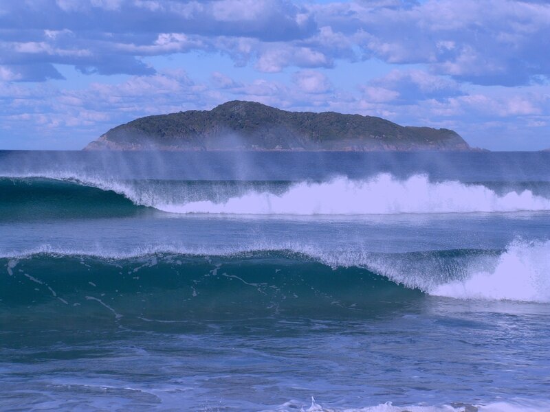 Ocean waves with island in background