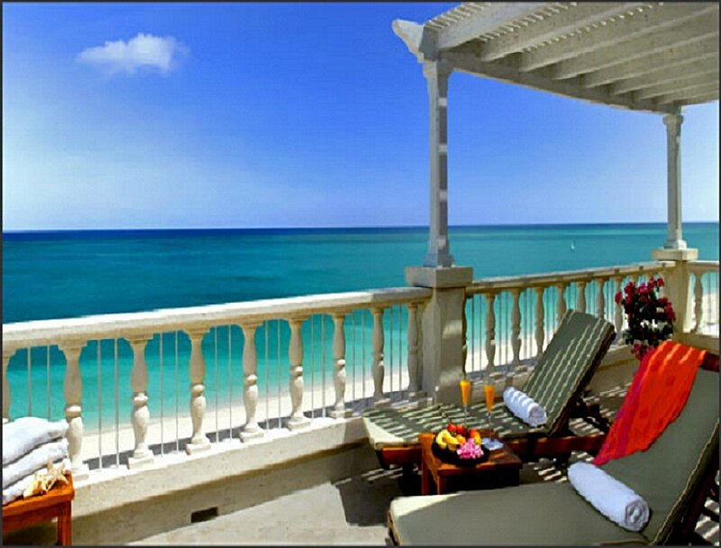 Oceanfront balcony with lounge chairs