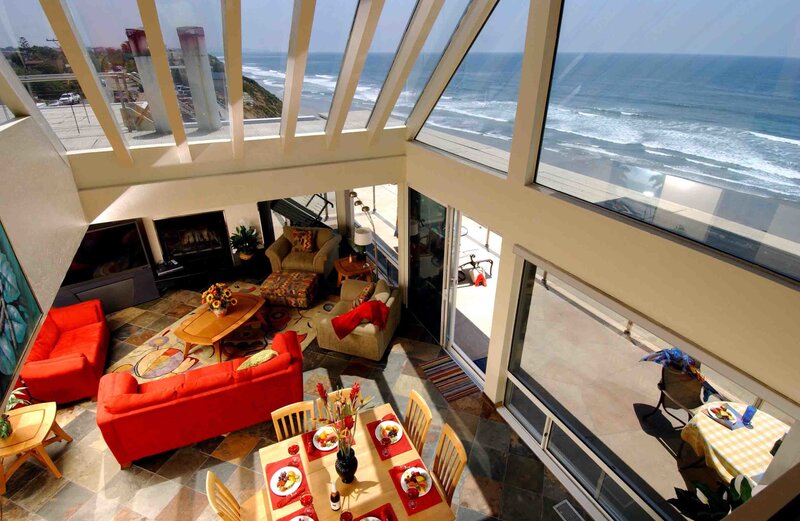 Oceanfront living room with red sofas
