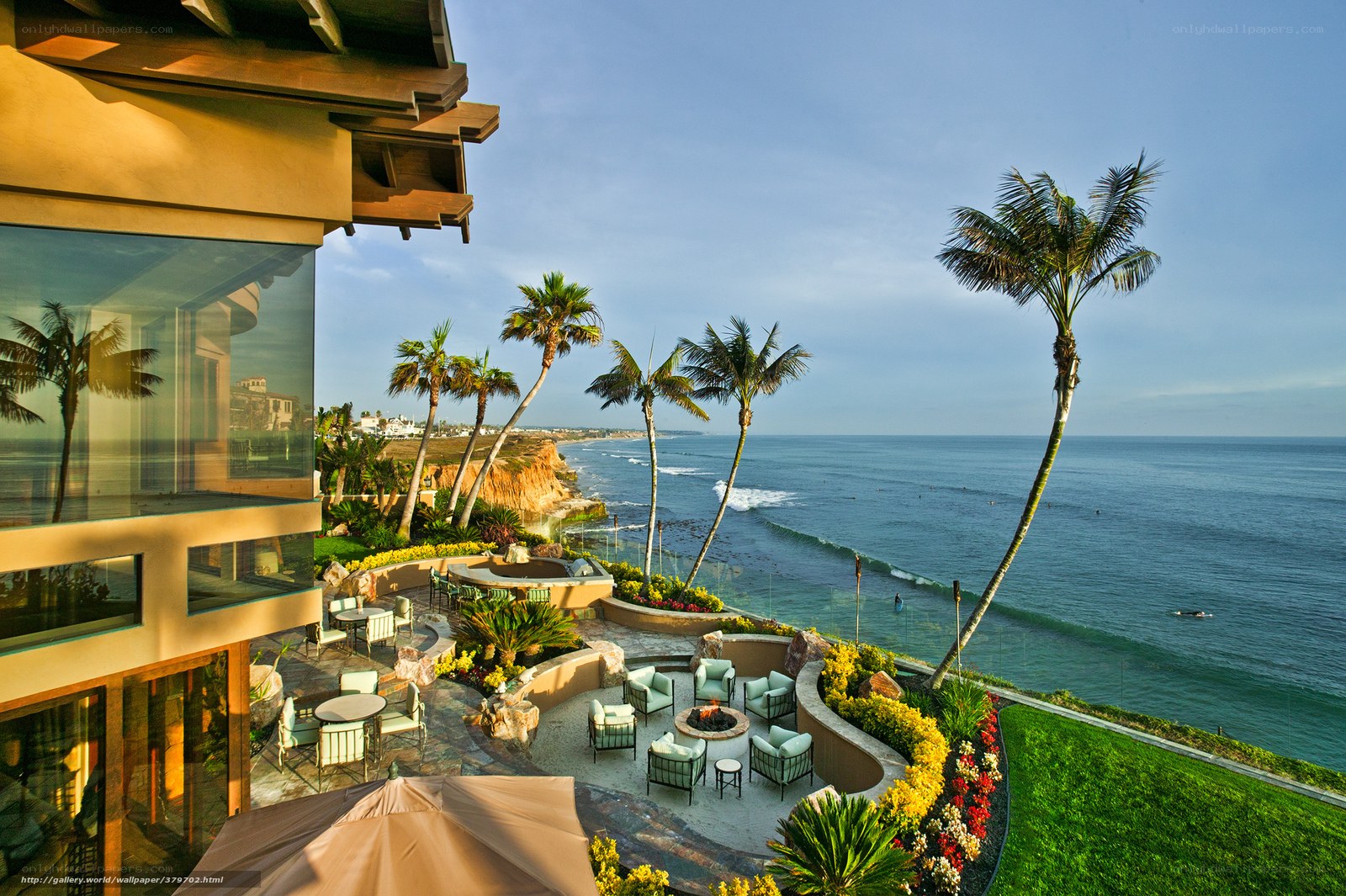 Oceanfront resort patio with palm trees