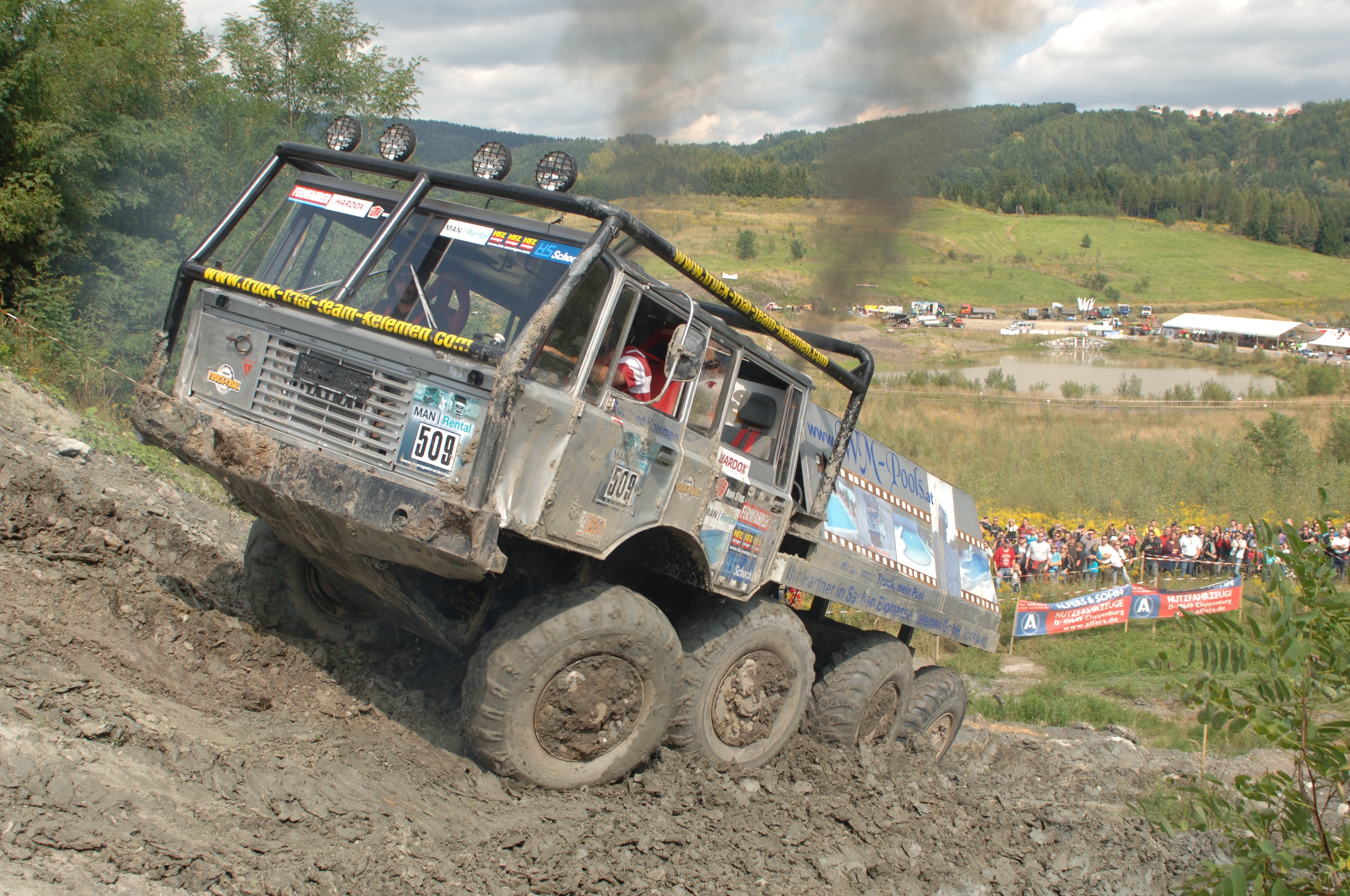 Off-road truck climbing muddy hill