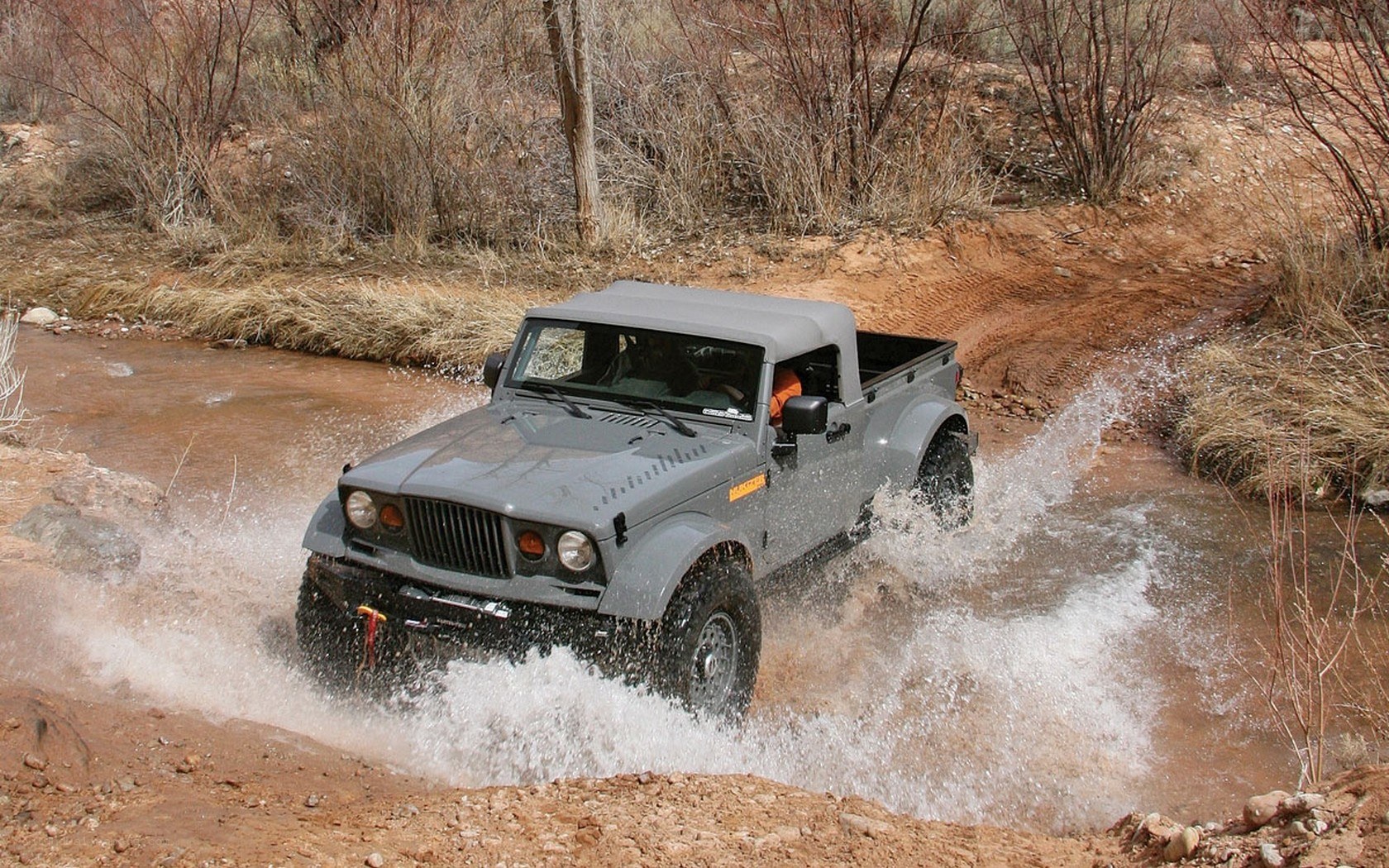 Off-road truck crossing stream