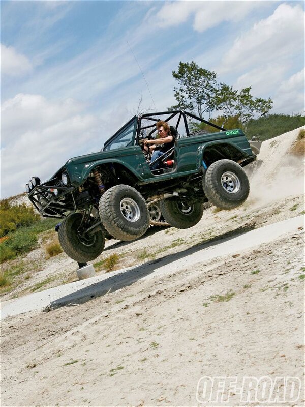 Off-road vehicle jumping a hill