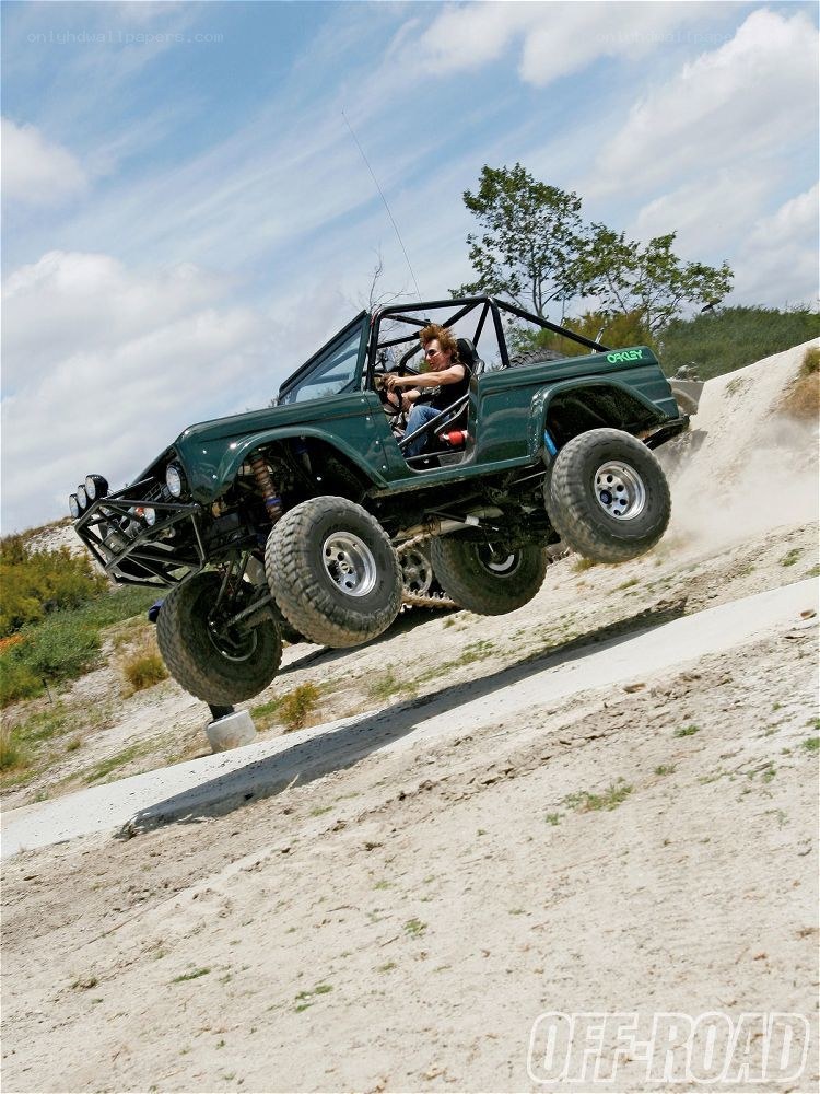 Off-road vehicle jumping a hill