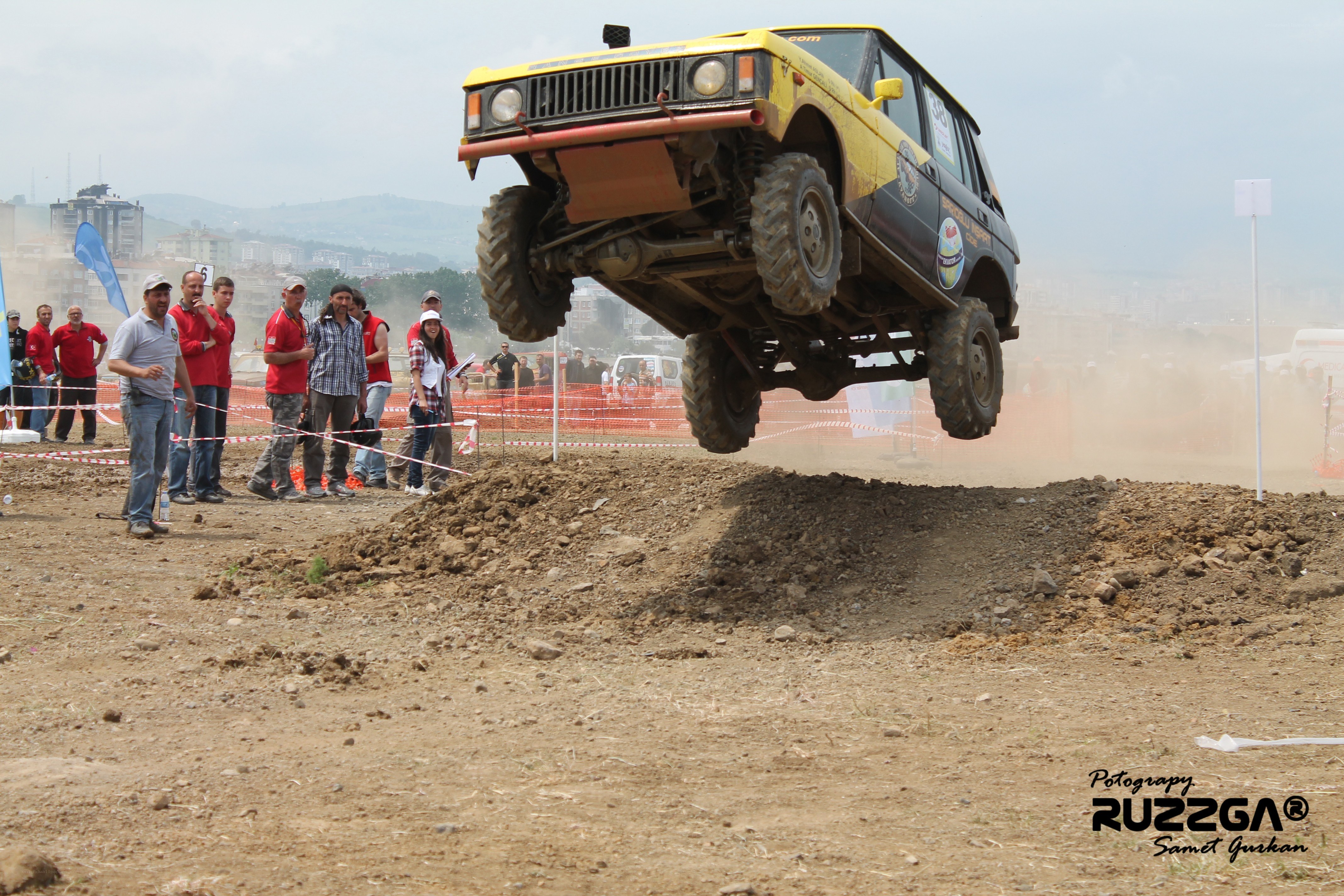 Off-road vehicle jumping over a mound