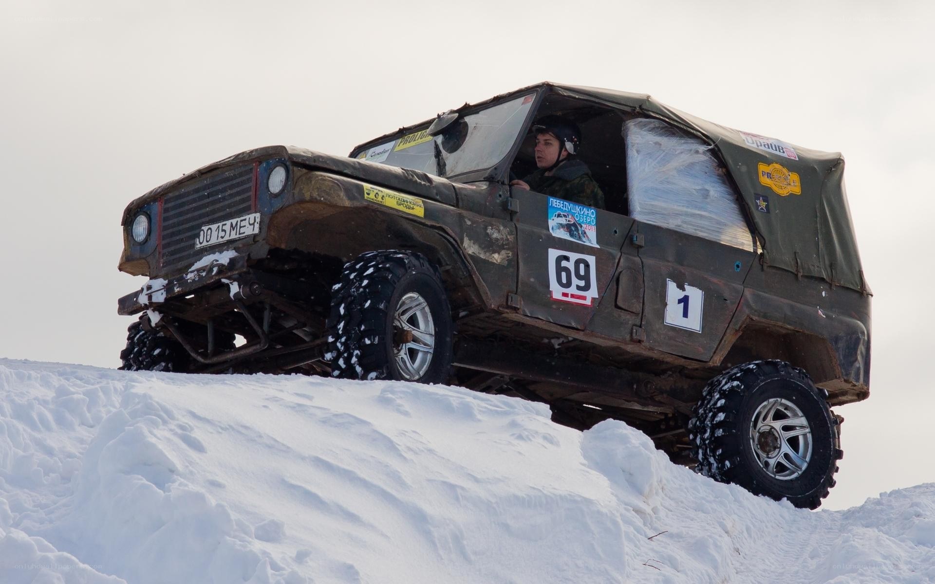 Off-road vehicle on snowy hill
