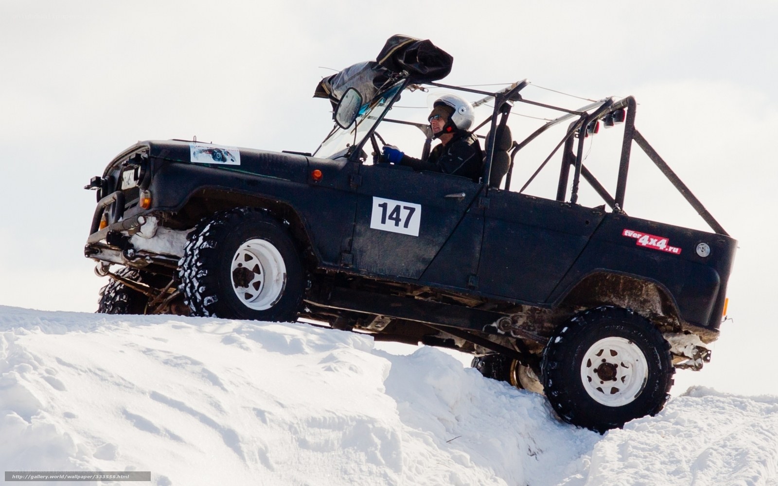 Off-road vehicle on snowy hill