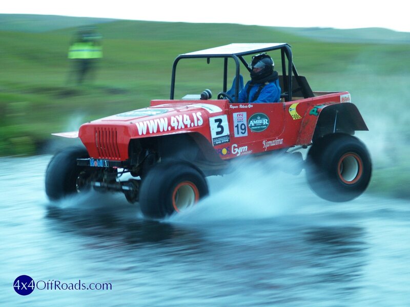 Off-road vehicle racing on wet terrain