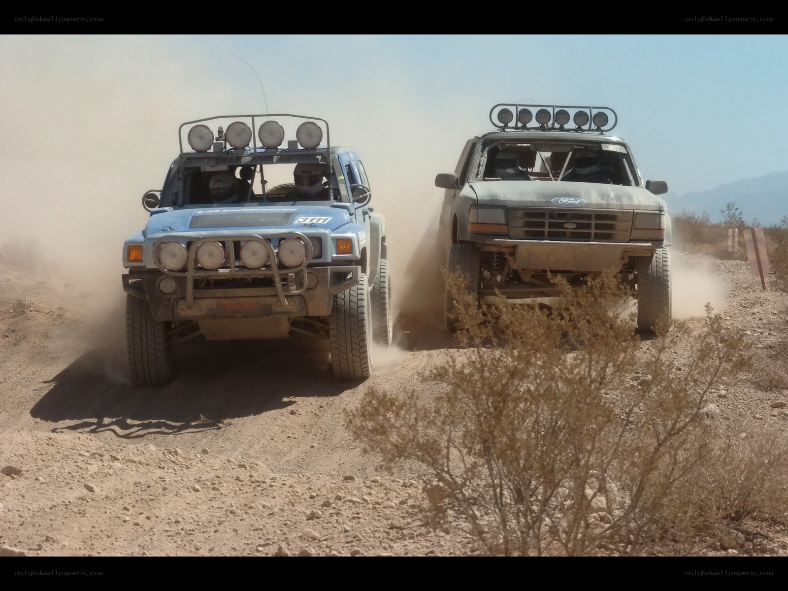 Off-road vehicles racing in desert