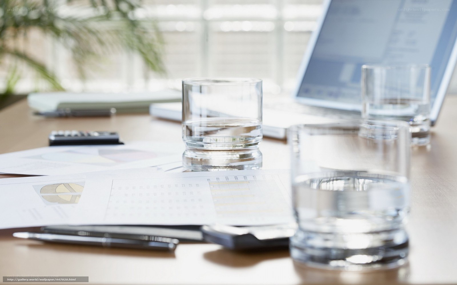 Office desk with documents and glasses